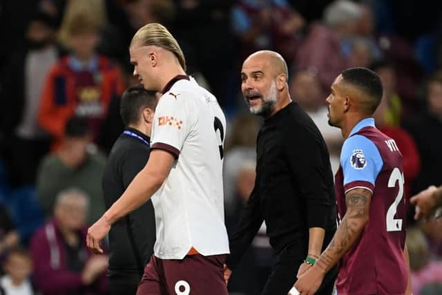 BURNLEY, ENGLAND - AUGUST 11: Josep Guardiola, Manager of Manchester City, speaks with Erling Haaland during the Premier League match between Burnley FC and Manchester City at Turf Moor on August 11, 2023 in Burnley, England. (Photo by Michael Regan/Getty Images)