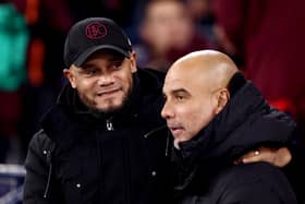 MANCHESTER, ENGLAND - JANUARY 31: Vincent Kompany, Manager of Burnley and Pep Guardiola, Manager of Manchester City embrace prior to the Premier League match between Manchester City and Burnley FC at Etihad Stadium on January 31, 2024 in Manchester, England. (Photo by Naomi Baker/Getty Images)