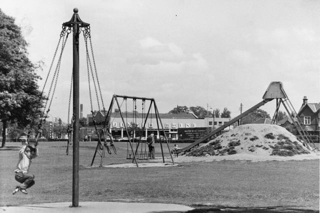 Look at the size of that slide! This picture was taken in 1965 - showing the communal provision of children's playgrounds such as this in Ashton Park, Preston, a fairly recent innovation on the British scene