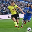 Burnley's Norwegian midfielder #16 Sander Berge (L) crosses the ball during the English Premier League football match between Chelsea and Burnley at Stamford Bridge in London on March 30, 2024. (Photo by Glyn KIRK / AFP) /