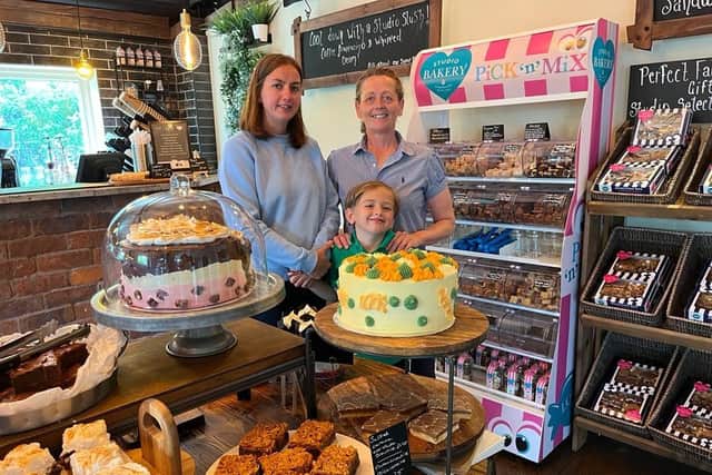 Allison Metcalf (right,) with her wife Lucy, and their son Ralph at their Studio Bakery shop