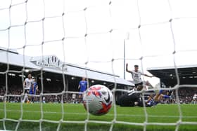 LONDON, ENGLAND - MAY 08: (EDITORS NOTE: Image has been taken using a Remote Camera behind the Goal.) Tom Cairney of Fulham scores the team's fourth goal as Daniel Iversen of Leicester City fails to make a save during the Premier League match between Fulham FC and Leicester City at Craven Cottage on May 08, 2023 in London, England. (Photo by Warren Little/Getty Images)