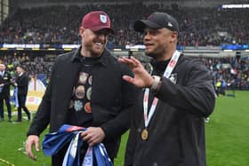 BURNLEY, ENGLAND - MAY 08: Vincent Kompany, Manager of Burnley speaks with NFL legend and Burnley FC stakeholder JJ Watt after defeating Cardiff City during the Sky Bet Championship between Burnley and Cardiff City at Turf Moor on May 08, 2023 in Burnley, England. (Photo by Gareth Copley/Getty Images)