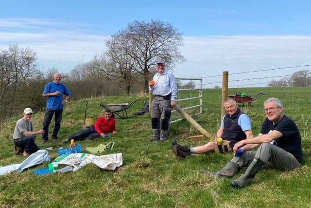 Job done - six of the volunteers take a well earned break after tree planting
