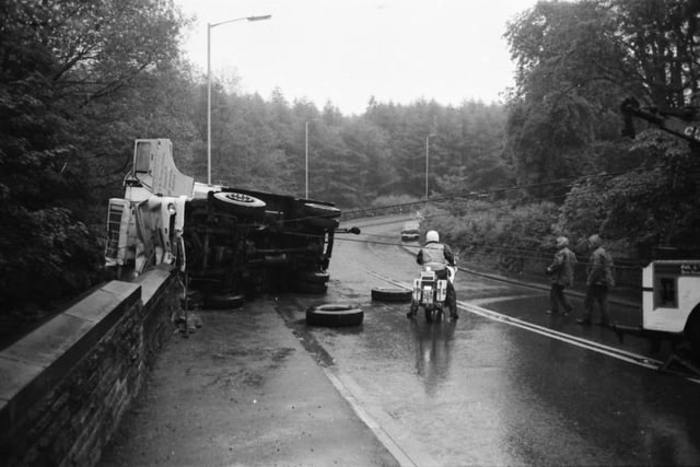 Devil's Elbow, Read. June 10, 1980.

The driver of this articulated lorry escaped with only a broken foot, as it smashed down seven yards of wall at Devil’s Elbow, Read. The lorry, loaded with lamb carcasses, was being driven towards Whalley when it left the road and ploughed into the bridge wall before coming to rest 20 feet above Sabden Brook. The driver Mr. Douglas Smith of Liverpool was taken to hospital, a car driver who collided with a road sign was unhurt. Traffic was delayed for more than two hours and another car collided with the cars waiting for the road to be cleared, the driver was unhurt.