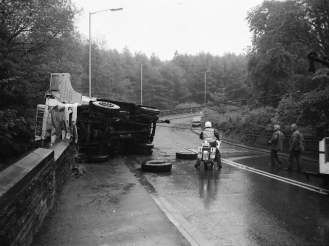Devil's Elbow, Read. June 10, 1980.

The driver of this articulated lorry escaped with only a broken foot, as it smashed down seven yards of wall at Devil’s Elbow, Read. The lorry, loaded with lamb carcasses, was being driven towards Whalley when it left the road and ploughed into the bridge wall before coming to rest 20 feet above Sabden Brook. The driver Mr. Douglas Smith of Liverpool was taken to hospital, a car driver who collided with a road sign was unhurt. Traffic was delayed for more than two hours and another car collided with the cars waiting for the road to be cleared, the driver was unhurt.