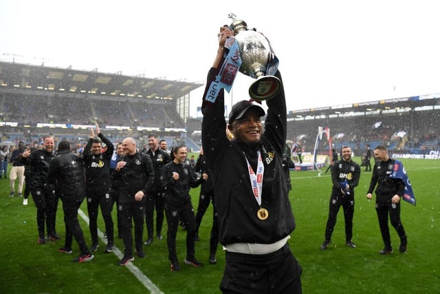 BURNLEY, ENGLAND - MAY 08: Vincent Kompany, Manager of Burnley celebrates with the Sky Bet Championship trophy celebrating promotion to the Premier League after defeating Cardiff City during the Sky Bet Championship between Burnley and Cardiff City at Turf Moor on May 08, 2023 in Burnley, England. (Photo by Gareth Copley/Getty Images)
