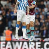 HUDDERSFIELD, ENGLAND - JULY 29: Danny Ward of Huddersfield Town is beaten to the ball by Charlie Taylor of Burnley during the Sky Bet Championship match between Huddersfield Town and Burnley at John Smith's Stadium on July 29, 2022 in Huddersfield, England. (Photo by Ashley Allen/Getty Images)