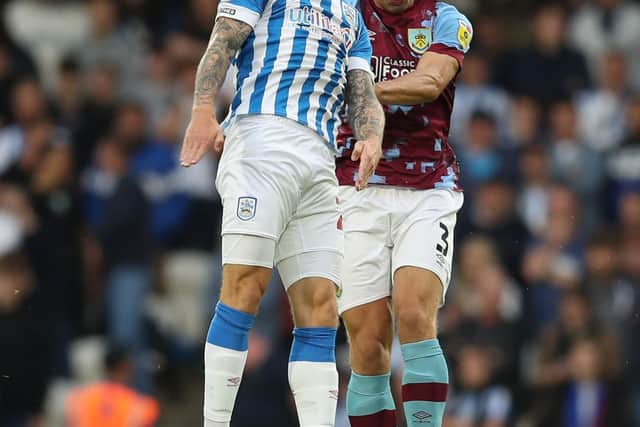 HUDDERSFIELD, ENGLAND - JULY 29: Danny Ward of Huddersfield Town is beaten to the ball by Charlie Taylor of Burnley during the Sky Bet Championship match between Huddersfield Town and Burnley at John Smith's Stadium on July 29, 2022 in Huddersfield, England. (Photo by Ashley Allen/Getty Images)