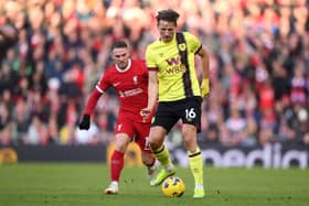LIVERPOOL, ENGLAND - FEBRUARY 10: Sander Berge of Burnley holds off Alexis Mac Allister of Liverpool during the Premier League match between Liverpool FC and Burnley FC at Anfield on February 10, 2024 in Liverpool, England. (Photo by Justin Setterfield/Getty Images)