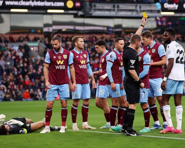 BURNLEY, ENGLAND - NOVEMBER 04: Odsonne Edouard of Crystal Palace is shown a yellow card by Referee Peter Bankes during the Premier League match between Burnley FC and Crystal Palace at Turf Moor on November 04, 2023 in Burnley, England. (Photo by Nathan Stirk/Getty Images)