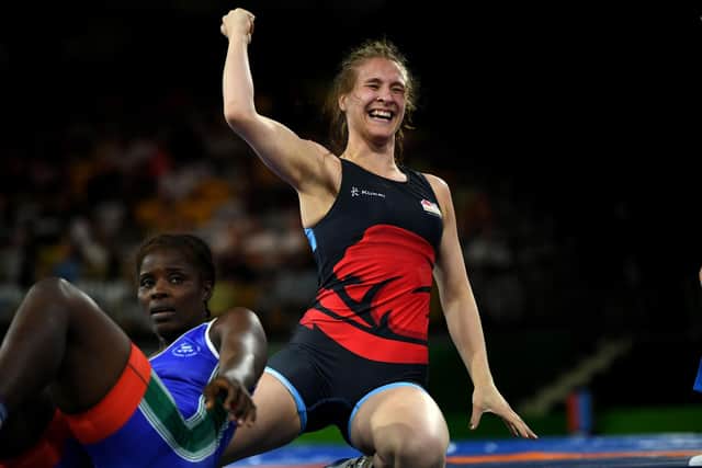 England's Georgina Nelthorpe (R) reacts after wrestling against Sierra Leone's Hajaratu Kamara (L) during the women's freestyle 76 kg bronze medal wrestling match at the 2018 Gold Coast Commonwealth Games in the Carrara Sports Arena on the Gold Coast on April 12, 2018. / AFP PHOTO / YE AUNG THU        (Photo credit should read YE AUNG THU/AFP via Getty Images)