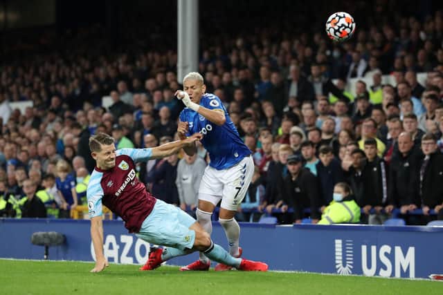 LIVERPOOL, ENGLAND - SEPTEMBER 13: Richarlison of Everton  is challenged by James Tarkowski of Burnley  during the Premier League match between Everton and Burnley at Goodison Park on September 13, 2021 in Liverpool, England.