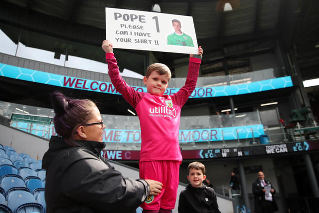 BURNLEY, ENGLAND - MAY 22: A young Burnley fan raises a message for Nick Pope of Burnley prior to the Premier League match between Burnley and Newcastle United at Turf Moor on May 22, 2022 in Burnley, England. (Photo by Jan Kruger/Getty Images)