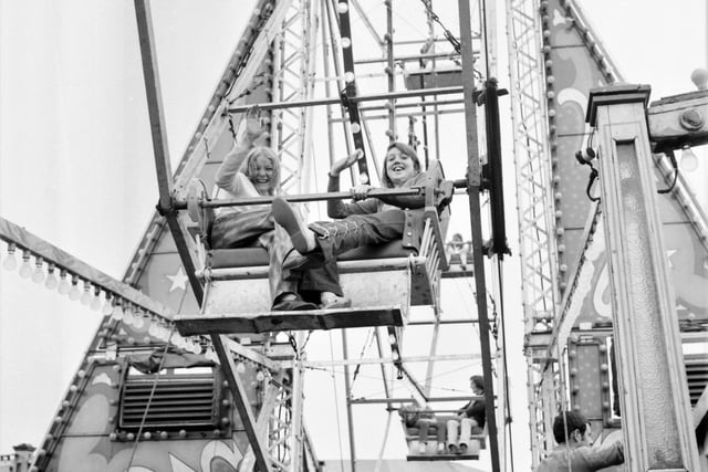 A happy smile and a wave from two Burnley girls on the big wheel. They are (left) 11-year-old Rosemary Charny of Rossendale Road and 12-year-old Diane Whitehead of Branch Road.
