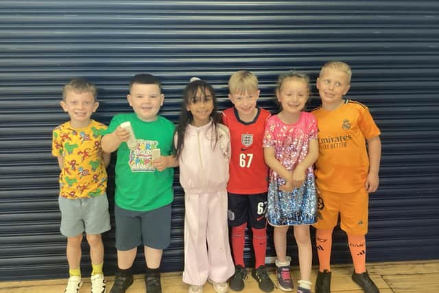 Reggie (second from left) with classmates who all dressed in bright colours to mark Rare Disease Day