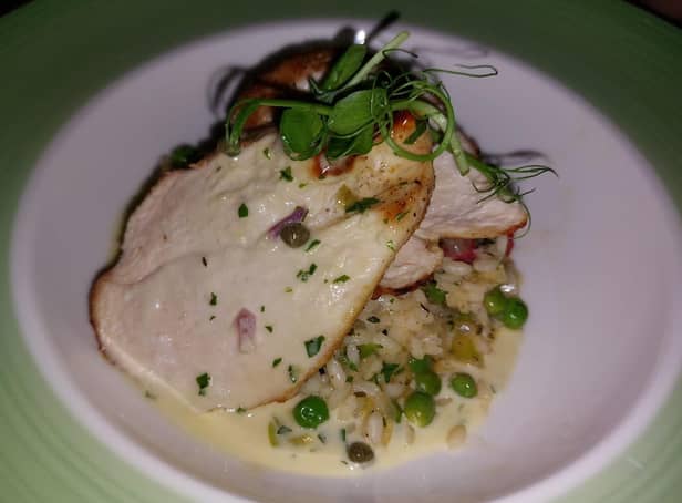 Roasted local chicken breast set on chorizo, pea and spring onion risotto, with a chive and white wine sauce