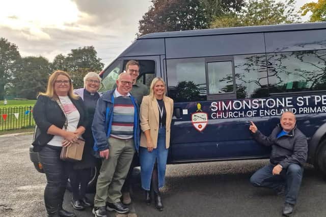 David Fishwick (far right) delivers the new minibus to Simonstone Primary watched by supporters including champion fund raiser Sarah Holt (far left) and headteacher Jill Cockings (far right)