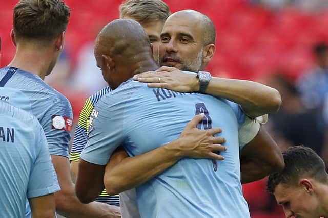 Manchester City's Spanish manager Pep Guardiola (R) embraces Manchester City's Belgian defender Vincent Kompany on the pitch after the English FA Community Shield football match between Chelsea and Manchester City at Wembley Stadium in north London on August 5, 2018. - Manchester City won the game 2-0. (Photo by Ian KINGTON / AFP) / NOT FOR MARKETING OR ADVERTISING USE / RESTRICTED TO EDITORIAL USE        (Photo credit should read IAN KINGTON/AFP via Getty Images)