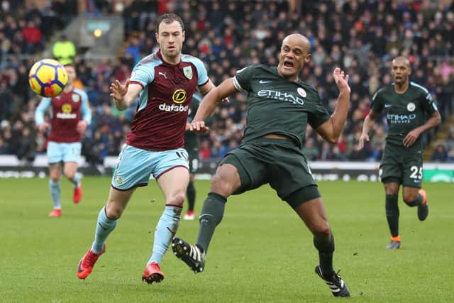 BURNLEY, ENGLAND - FEBRUARY 03: Ashley Barnes of Burnley vies with Vincent Kompany of Manchester City during the Premier League match between Burnley and Manchester City at Turf Moor on February 3, 2018 in Burnley, England. (Photo by Ian MacNicol/Getty Images)