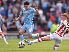 STOKE ON TRENT, ENGLAND - MAY 07: Callum O'Hare of Coventry City runs past Sam Clucas of Stoke City during the Sky Bet Championship match between Stoke City and Coventry City at Bet365 Stadium on May 07, 2022 in Stoke on Trent, England. (Photo by Nathan Stirk/Getty Images)