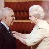 Brian Hall receiving his MBE from the late Queen Elizabeth II