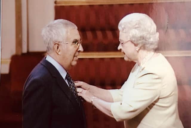 Brian Hall receiving his MBE from the late Queen Elizabeth II