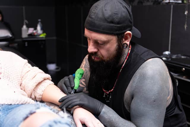 Wayne Porter works on a tattoo at Acherontia Tattoo Studio in Hall Street, Burnley. Photo: Kelvin Stuttard