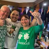 Martin Maughan (centre) the owner of The Coal Clough pub in Burnley celebrates St Patrick's Day with two customers. Martin has started a new initiative at the pub offering free food and a hot drink to the homless and vulnerable on Monday afternoons