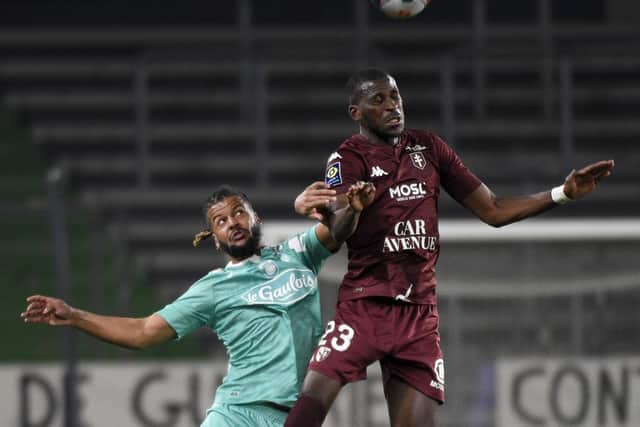 Metz' Malian defender Boubacar Kouyate (R) fights for the ball with Angers' French forward Lois Diony during the French L1 football match between Football Club de Metz and Angers SCO at the Saint-Symphorien Stadium in Longeville-Les-Metz, eastern France on March 3, 2021. (Photo by JEAN CHRISTOPHE VERHAEGEN / AFP) (Photo by JEAN CHRISTOPHE VERHAEGEN/AFP via Getty Images)