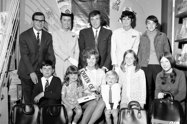 Brenda Day (centre) surrounded by the prize winners (left front): John J. Cunliffe, Carole Georgeson, Michael J. Hare, Joanna L. Holdsworth and Linda J. Bardsley. Standing at the back are (from left) Alan Casey (manager of BCA Travel in Burnley), Simonetta Piekosz, David Houghton, Yvonne Sutton, and prize winner David Lango.
Six local youngsters met the Queen of Industry, Brenda Day, when she made the presentations to winners of the Burnley Express Family Circle painting competition run in association with BCA Travel Ltd and BIA.