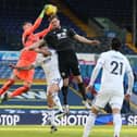 Leeds United's French goalkeeper Illan Meslier (L) catches the ball under pressure from Burnley's New Zealand striker Chris Wood (R) during the English Premier League football match between Leeds United and Burnley at Elland Road. (Photo by NIGEL FRENCH/POOL/AFP via Getty Images)