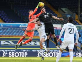 Leeds United's French goalkeeper Illan Meslier (L) catches the ball under pressure from Burnley's New Zealand striker Chris Wood (R) during the English Premier League football match between Leeds United and Burnley at Elland Road. (Photo by NIGEL FRENCH/POOL/AFP via Getty Images)