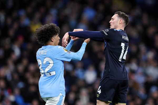 MANCHESTER, ENGLAND - JANUARY 31: Rico Lewis of Manchester City clashes with Connor Roberts of Burnley during the Premier League match between Manchester City and Burnley FC at Etihad Stadium on January 31, 2024 in Manchester, England. (Photo by Alex Livesey/Getty Images)