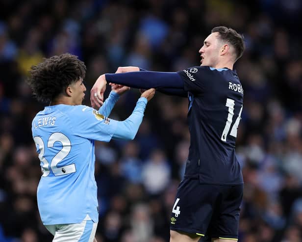 MANCHESTER, ENGLAND - JANUARY 31: Rico Lewis of Manchester City clashes with Connor Roberts of Burnley during the Premier League match between Manchester City and Burnley FC at Etihad Stadium on January 31, 2024 in Manchester, England. (Photo by Alex Livesey/Getty Images)