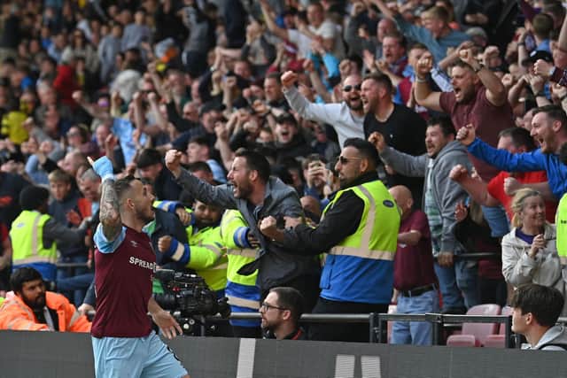 Burnley's English midfielder Josh Brownhill (L) celebrates in front of supporters after scoring their second goal during the English Premier League football match between Watford and Burnley at Vicarage Road Stadium in Watford, north-west of London, on April 30, 2022. - Burnley won the game 2-1.