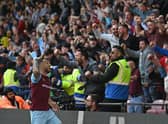 Burnley's English midfielder Josh Brownhill (L) celebrates in front of supporters after scoring their second goal during the English Premier League football match between Watford and Burnley at Vicarage Road Stadium in Watford, north-west of London, on April 30, 2022. - Burnley won the game 2-1.