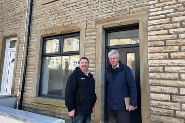 Councillor John Harbour (right) with Burnley Council housing officer John Killion outside a newly refurbished property in Burnley