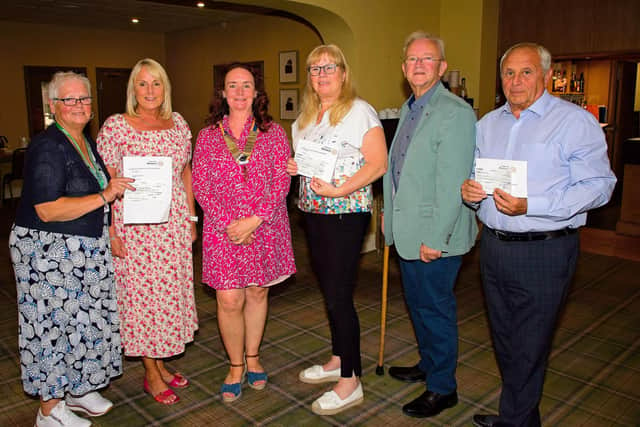 Representatives from Macmillan Cancer Support, ELHT&;Me, and RV Crossroads Care with outgoing Clitheroe Rotary Club president Karin Wilson and incoming president Robert Irwin.