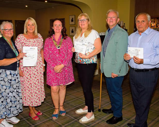 Representatives from Macmillan Cancer Support, ELHT&;Me, and RV Crossroads Care with outgoing Clitheroe Rotary Club president Karin Wilson and incoming president Robert Irwin.