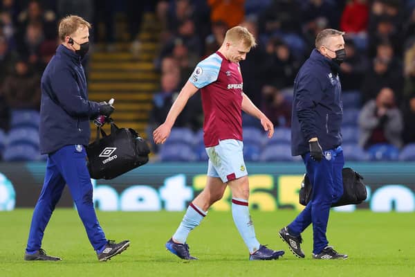 BURNLEY, ENGLAND - MARCH 01: Ben Mee of Burnley leaves the field with an injury during the Premier League match between Burnley and Leicester City at Turf Moor on March 01, 2022 in Burnley, England.
