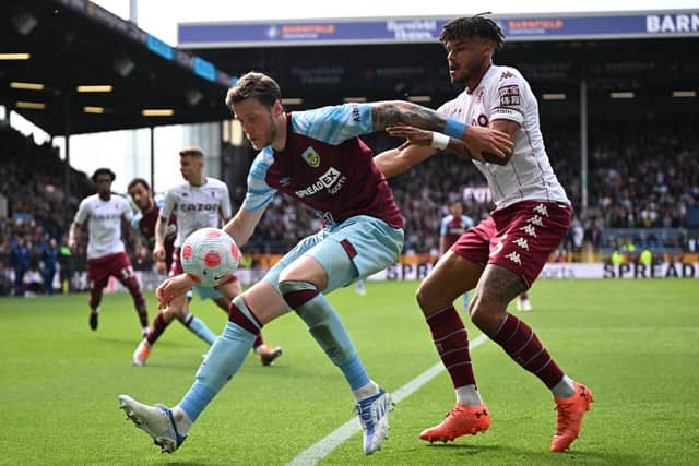 Burnley's Dutch striker Wout Weghorst (L) vies with Aston Villa's English defender Tyrone Mings (R) during the English Premier League football match between Burnley and Aston Villa at Turf Moor in Burnley, north west England on May 7, 2022.