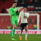 England's goalkeeper Nick Pope (L) and Englands's midfielder Phil Foden chat on the pitch after the international friendly football match between England and Ivory Coast at Wembley stadium in north London on March 29, 2022.