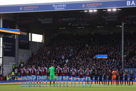 BURNLEY, ENGLAND - MARCH 05: Players, officials and fans take part in a minute of applause to indicate peace and sympathy with Ukraine prior to the Premier League match between Burnley and Chelsea at Turf Moor on March 05, 2022 in Burnley, England.