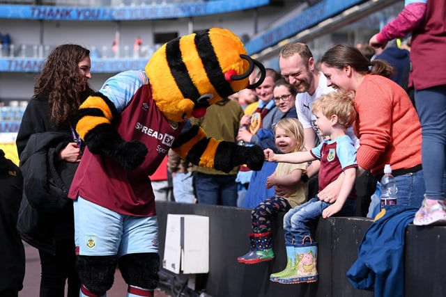 BURNLEY, ENGLAND - APRIL 24: Burnley mascot celebrates with the fans after their sides victory during the Premier League match between Burnley and Wolverhampton Wanderers at Turf Moor on April 24, 2022 in Burnley, England. (Photo by Stu Forster/Getty Images)