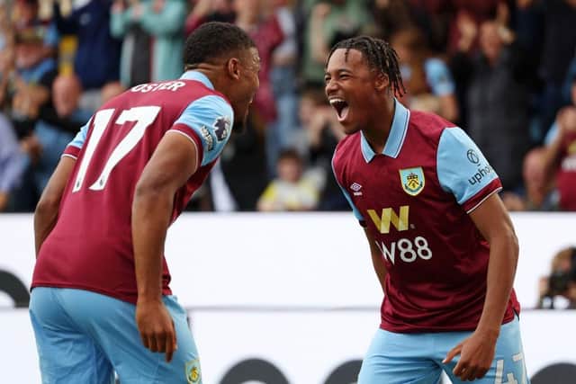 BURNLEY, ENGLAND - OCTOBER 07: Wilson Odobert of Burnley celebrates with team mate Lyle Foster after scoring their sides first goal during the Premier League match between Burnley FC and Chelsea FC at Turf Moor on October 07, 2023 in Burnley, England. (Photo by Matt McNulty/Getty Images)