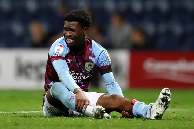 PRESTON, ENGLAND - SEPTEMBER 13: Nathan Tella of Burnley reacts after picking up an injury during the Sky Bet Championship between Preston North End and Burnley at Deepdale on September 13, 2022 in Preston, England. (Photo by Lewis Storey/Getty Images)