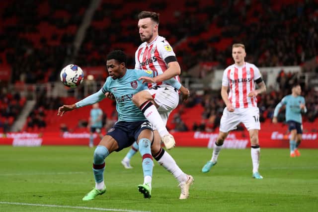 STOKE ON TRENT, ENGLAND - DECEMBER 30: Nathan Tella of Burnley is challenged by Morgan Fox of Stoke City during the Sky Bet Championship match between Stoke City and Burnley at Bet365 Stadium on December 30, 2022 in Stoke on Trent, England. (Photo by Charlotte Tattersall/Getty Images)