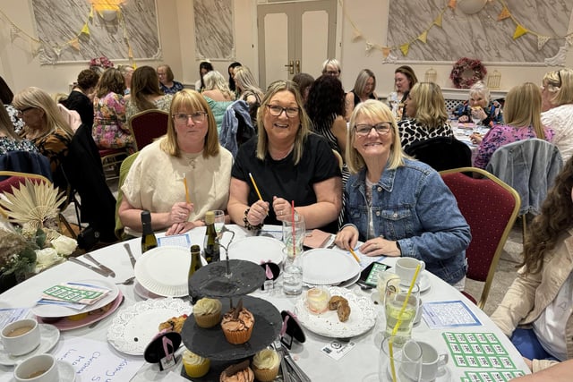 People attending an afternoon tea fundraiser hosted by Michelle Williamson in aid of Pendleside Hospice and The Brain Tumour Charity.