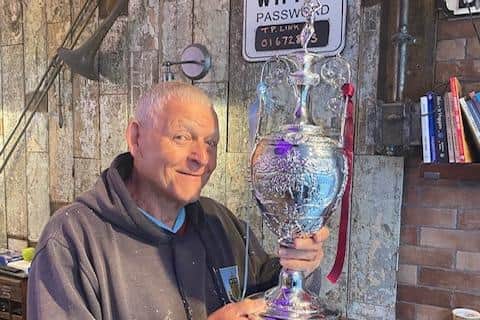 Burnley football fans can have their photo taken with a replica of the Championship trophy at Jazzman Grooves barber's shop in Bull Street, Burnley, today